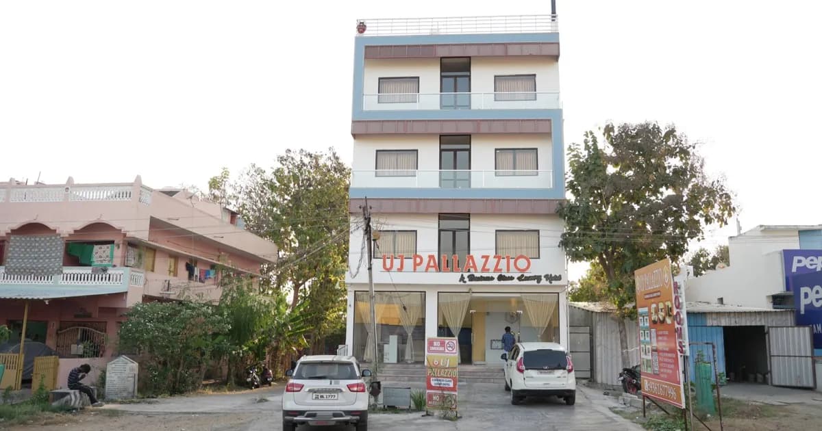 UJ Pallazzio on the Tiruvannamalai Bypass Road with self-drive guest cars parked outside — the arrival point for the Bengaluru route