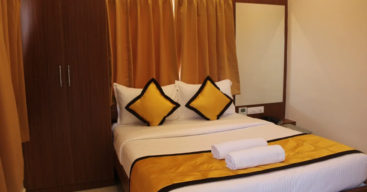 Clean, quiet air-conditioned room at UJ Pallazzio — a practical base for business and medical travel near GMC Hospital, Tiruvannamalai
