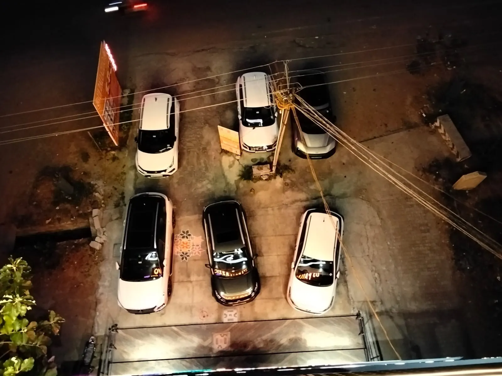 Top view of the private on-site car parking area at UJ Pallazzio with cars parked, Tiruvannamalai