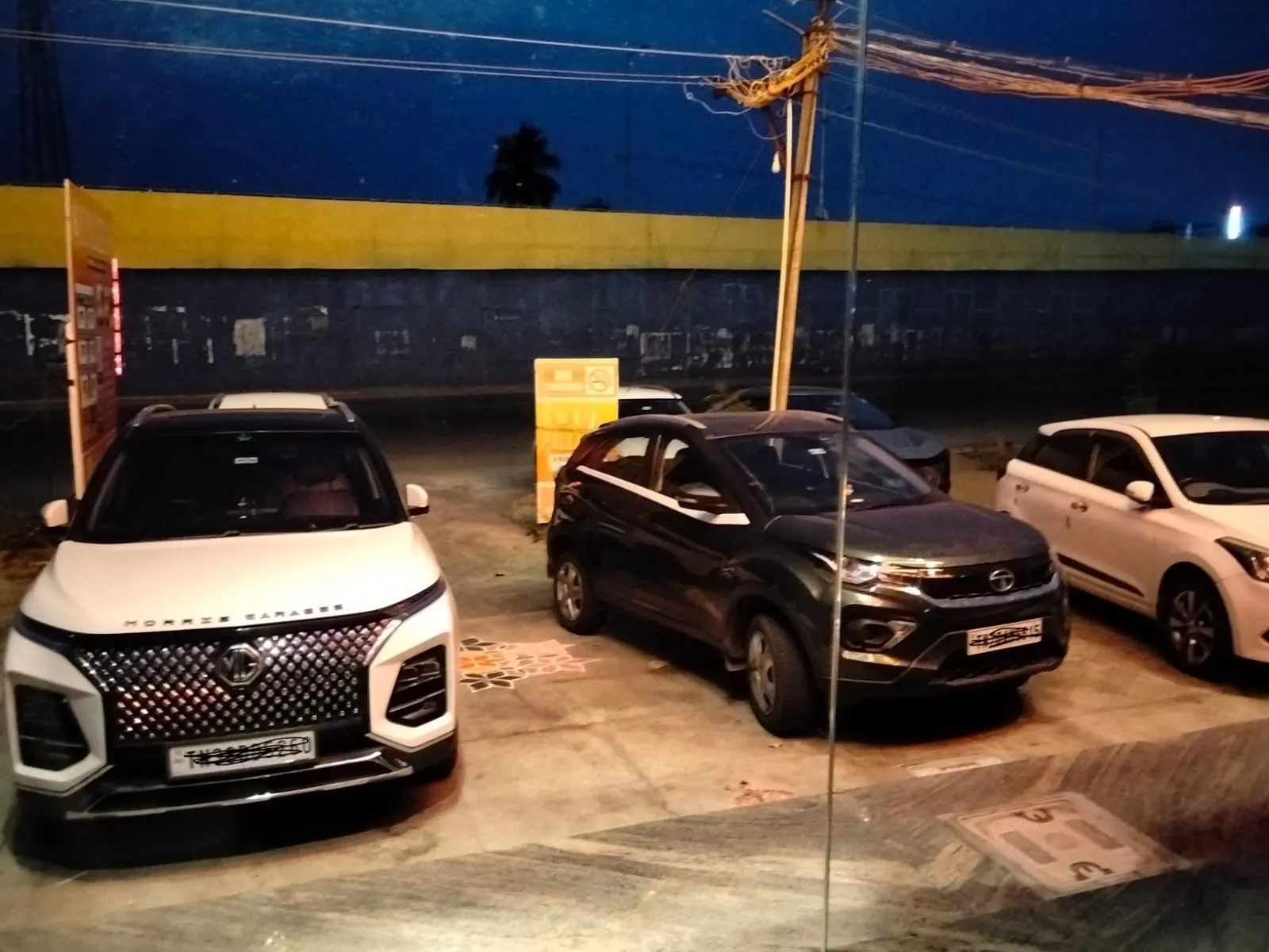 Guest cars and SUVs parked in the secure, CCTV-monitored parking at UJ Pallazzio, Tiruvannamalai